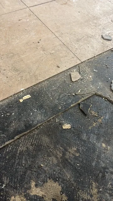 Black bitumen mastic floor removal in a N6 flat